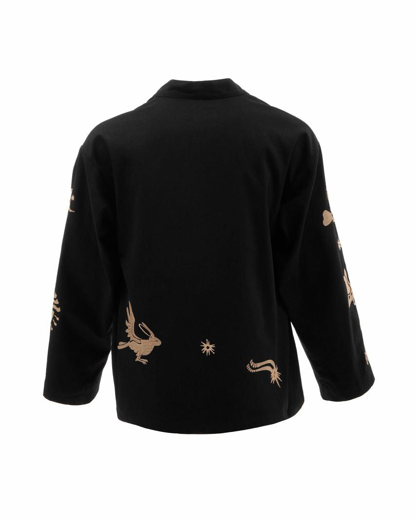 Black top with gold embroidery on a white background