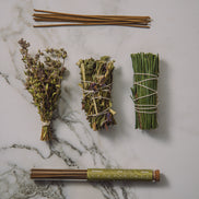 Herbal bundles tied with twine on a marble surface
