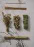 Herbal bundles tied with twine on a marble surface