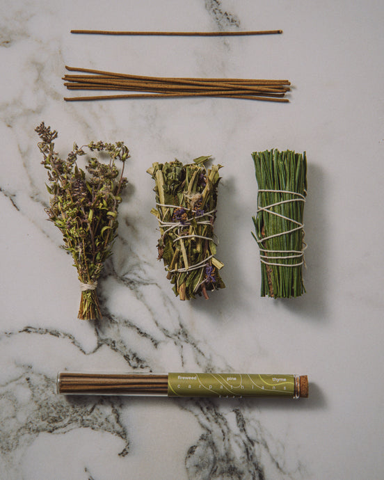 Herbal bundles tied with twine on a marble surface