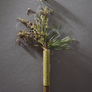 Dried floral arrangement on a dark gray background
