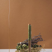 Incense stick with smoke and decorative elements on a brown background