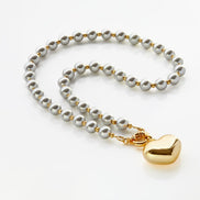 Golden Heart Necklace on Grey Pearls