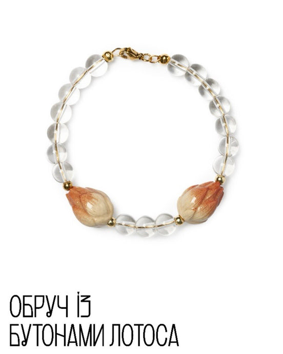 Bracelet with clear beads and lotus flower petals on a white background