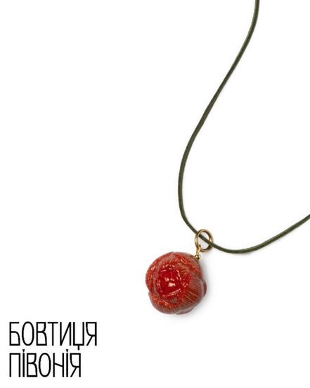 Necklace with a red pendant on a white background