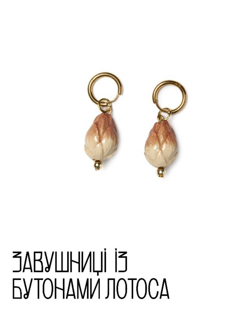 Pair of earrings with wooden beads on a white background